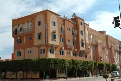 a large brick building on a city street at Hotel Marmar in Ouarzazate