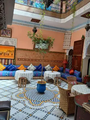a living room with two tables and a couch at Riad Idrissi in Meknès