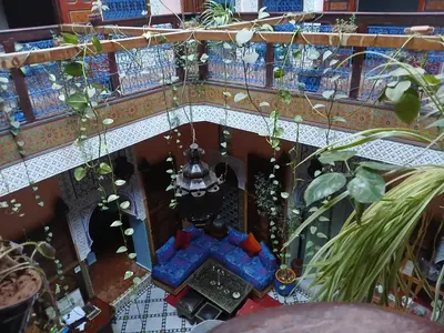 an overhead view of a balcony with plants and a fountain at Riad Idrissi in Meknès