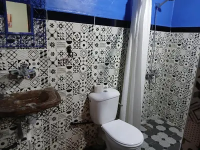 a bathroom with a toilet and a sink at Riad Idrissi in Meknès