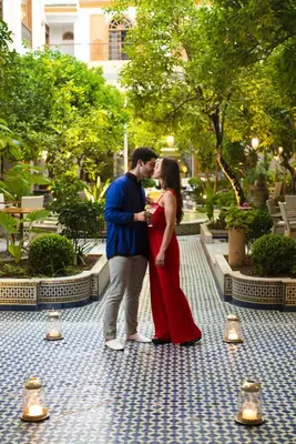 a man and a woman kissing in a garden at Palais Amani in Fès