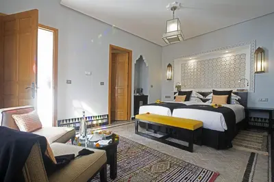 a large bedroom with two beds and a couch at Palais Amani in Fès