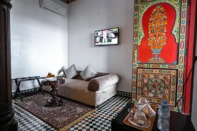 a living room with a couch and a large wall at Palais Houyam in Fès