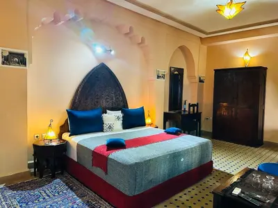 a bedroom with a large bed in a room at Riad Ahlam in Fès