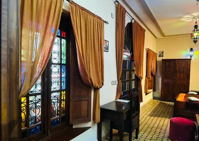 a room with a window and a desk in a room at Riad Ahlam in Fès