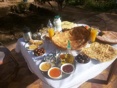 a table with a bunch of food on it at Bassatine Skoura in Skoura