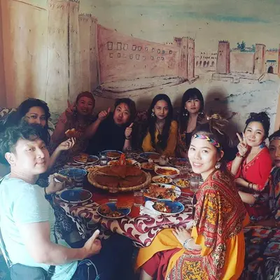 a group of people sitting around a table at Panorama chez Hamid in Rissani