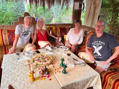 a group of people sitting around a table at Paradis Touareg in Zagora