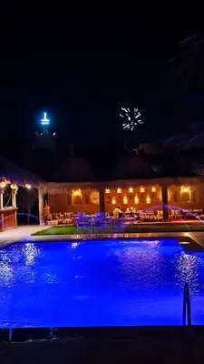 a swimming pool at night with blue lights at Paradis Touareg in Zagora