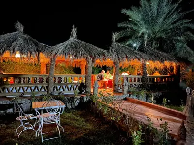 a couple sitting in a pavilion at night at Paradis Touareg in Zagora