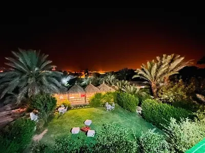 an aerial view of a house with palm trees at night at Paradis Touareg in Zagora