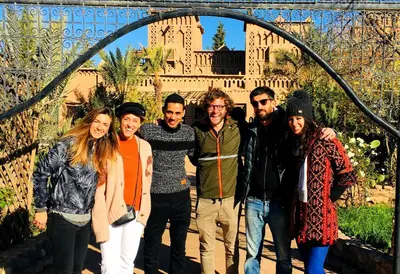 a group of people posing for a picture under an arch at Kasbah Tiriguioute in Skoura
