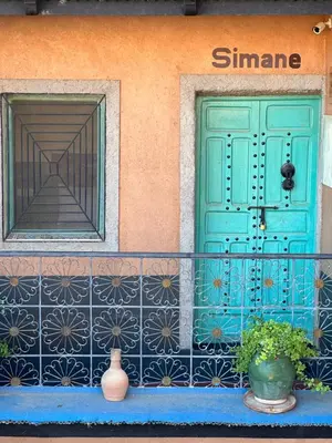 a house with a blue door and a window at Labyrinth Kasbah Dades in Ait Ben Ali