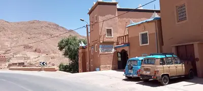 an old car parked on the side of a street at Labyrinth Kasbah Dades in Ait Ben Ali