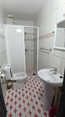 a bathroom with a toilet and a sink at Residence Rosas in Ouarzazate