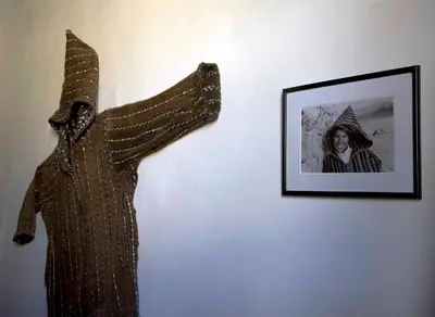 a dress hanging on a wall next to a picture at Riad Al Bartal in Fès