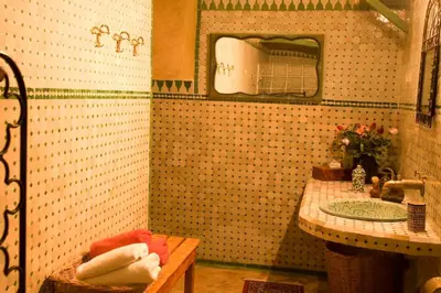 a bathroom with a sink and a mirror at Riad Al Bartal in Fès