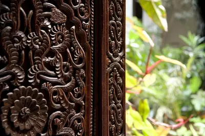 a wooden door with a flower design on it at Riad Al Bartal in Fès