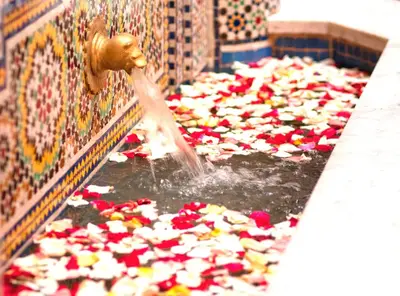 a fire hydrant filled with red and white flowers at Riad-Boutique Borj Dhab Fez in Fès