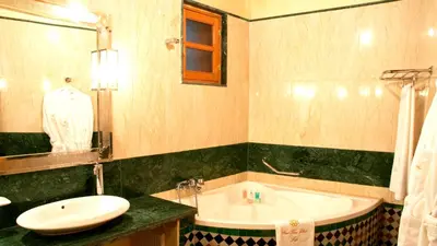 a bathroom with a sink and a bath tub at Riad-Boutique Borj Dhab Fez in Fès