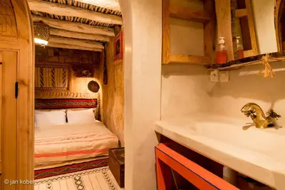a bathroom with a sink and a bed in a room at Dar KamalChaoui in Bhalil