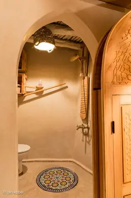 a bathroom with a shower and a toilet and a door at Dar KamalChaoui in Bhalil