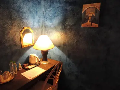 a table with a lamp and a telephone on it at Dar Qamar in Agdz