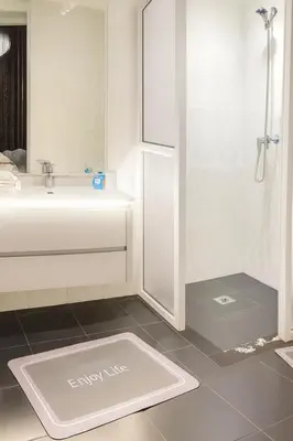 a white bathroom with a sink and a shower at Chalet Asmoun in Imouzzer Kandar