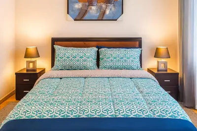 a bedroom with a blue bed with two night stands at Chalet Asmoun in Imouzzer Kandar