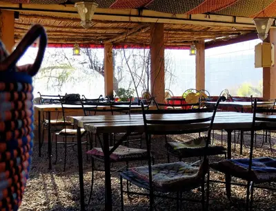 a group of tables and chairs in a pavilion at Camping Auberge Zebra in Ouzoud