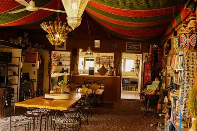 a room with a table and chairs in a store at Camping Auberge Zebra in Ouzoud