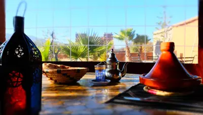 a table with various items on it with a window at Camping Auberge Zebra in Ouzoud