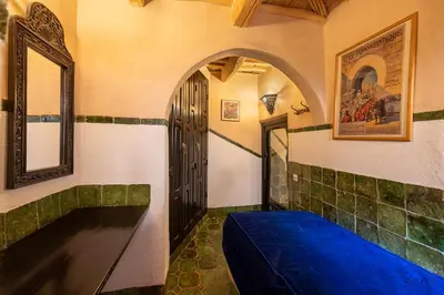 a room with a blue bed and a door at Hôtel Riad Dar Daïf in Ouarzazate