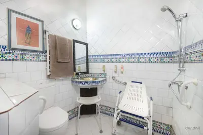 a bathroom with a sink and a toilet and a shower at Hôtel Riad Dar Daïf in Ouarzazate