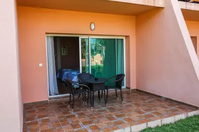 a patio with chairs and a table on a porch at Hotel Dar Eddaya in Khemisset