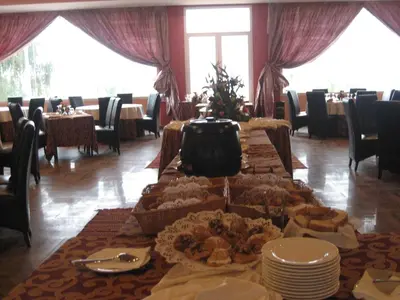 a table with food on it in a restaurant at Hotel Dar Eddaya in Khemisset