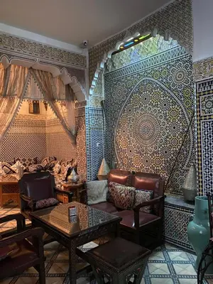 a living room with a couch and a table at Riad Lahboul in Meknès