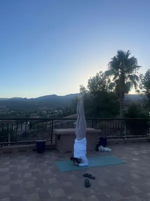a woman doing a yoga pose on a bench at Chez Mamouchthka in Ourika