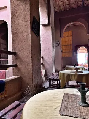 a room with a table and a bed in a building at Kasbah Oulad Othmane in Agoubt