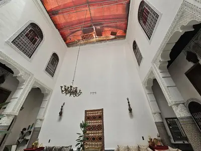 a large room with a chandelier in a building at Riad Lalla Zoubida in Fès