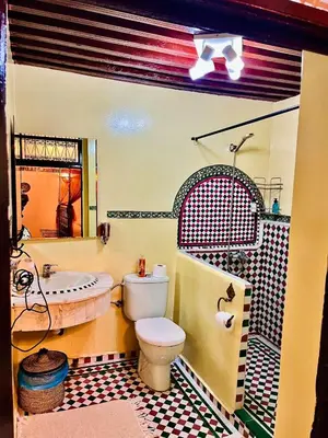 a bathroom with a sink and a toilet and a tub at Riad Lalla Zoubida in Fès
