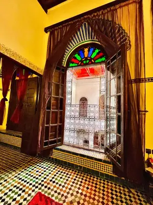 a room with a door with a stained glass window at Riad Lalla Zoubida in Fès