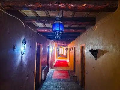 an alley way with a blue light hanging from a ceiling at Hotel Taddart in Midelt