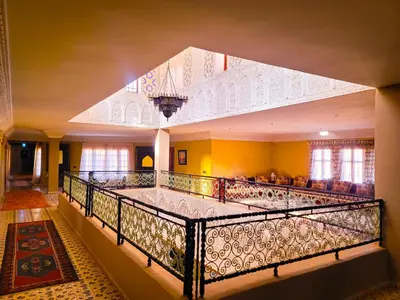 a large room with a bed in a building at Hotel Taddart in Midelt