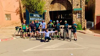 a group of people posing for a picture with their bikes at Hotel Restaurant La Kasbah in Tinerhir