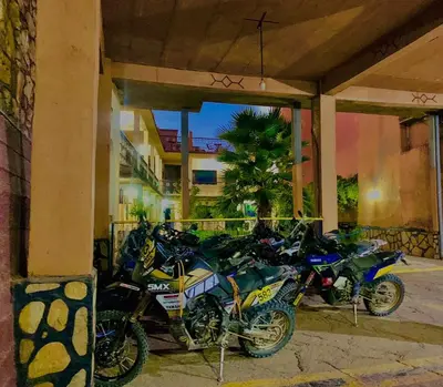 a group of motorcycles parked under a building at Hotel Restaurant La Kasbah in Tinerhir