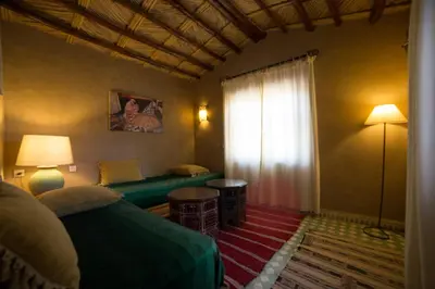 a living room with a couch and a window at Kasbah Hotel Panorama in Merzouga