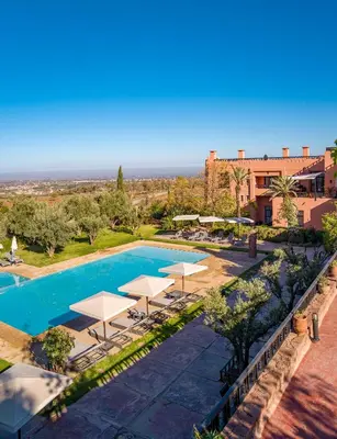 an overhead view of a swimming pool with umbrellas at Kasbah Agounsane Hotel & Spa in Ourika