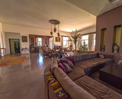 a living room with a couch and a dining room at Kasbah Agounsane Hotel & Spa in Ourika