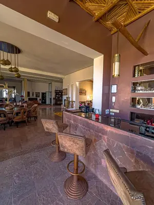 a bar with chairs and a counter in a restaurant at Kasbah Agounsane Hotel & Spa in Ourika